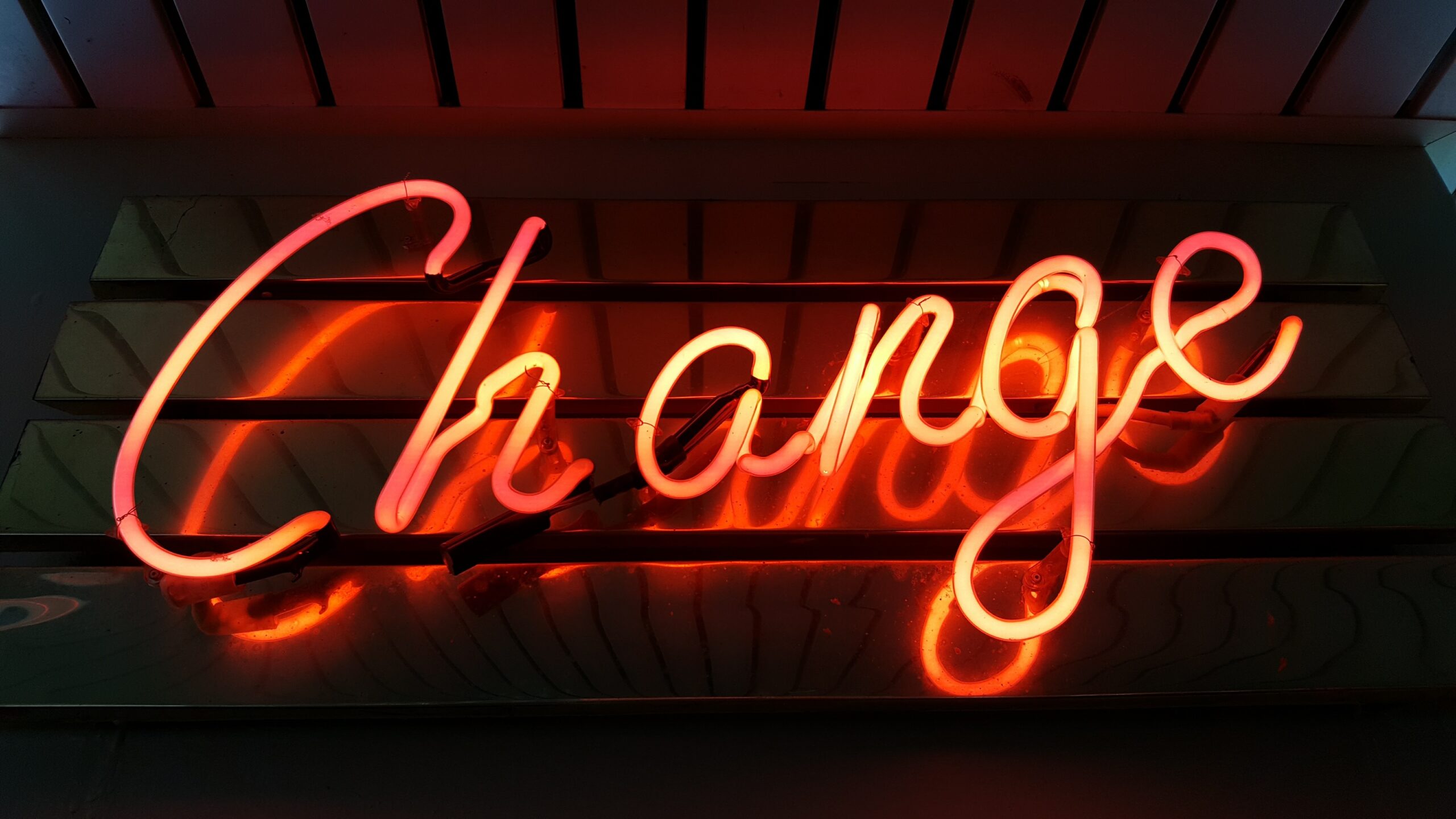 Neon sign showing change that allows a person to change